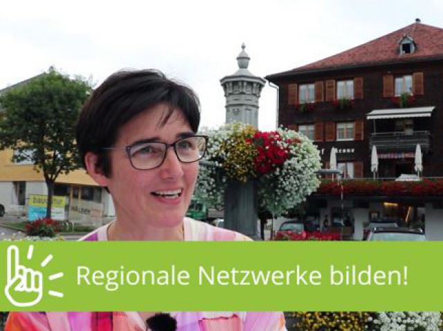 Aussschnitt aus einem Film. Frau steht in Ortszentrum.