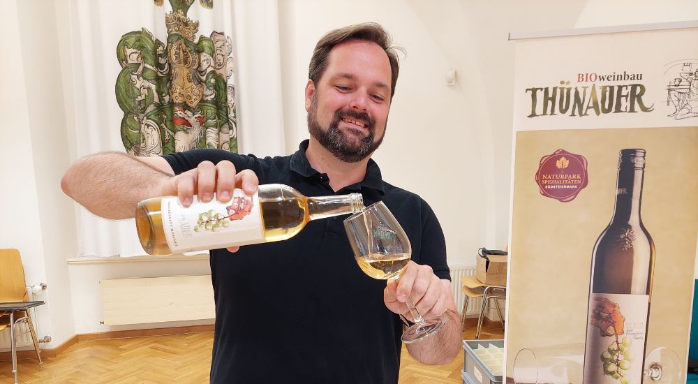 Man schenkt Wein in Weinglas ein